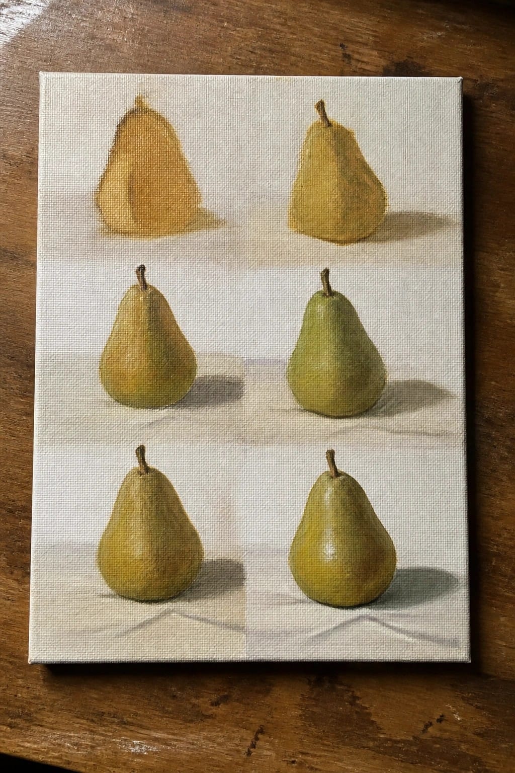 Six yellow-green pears painted in rows with shadows on white canvas