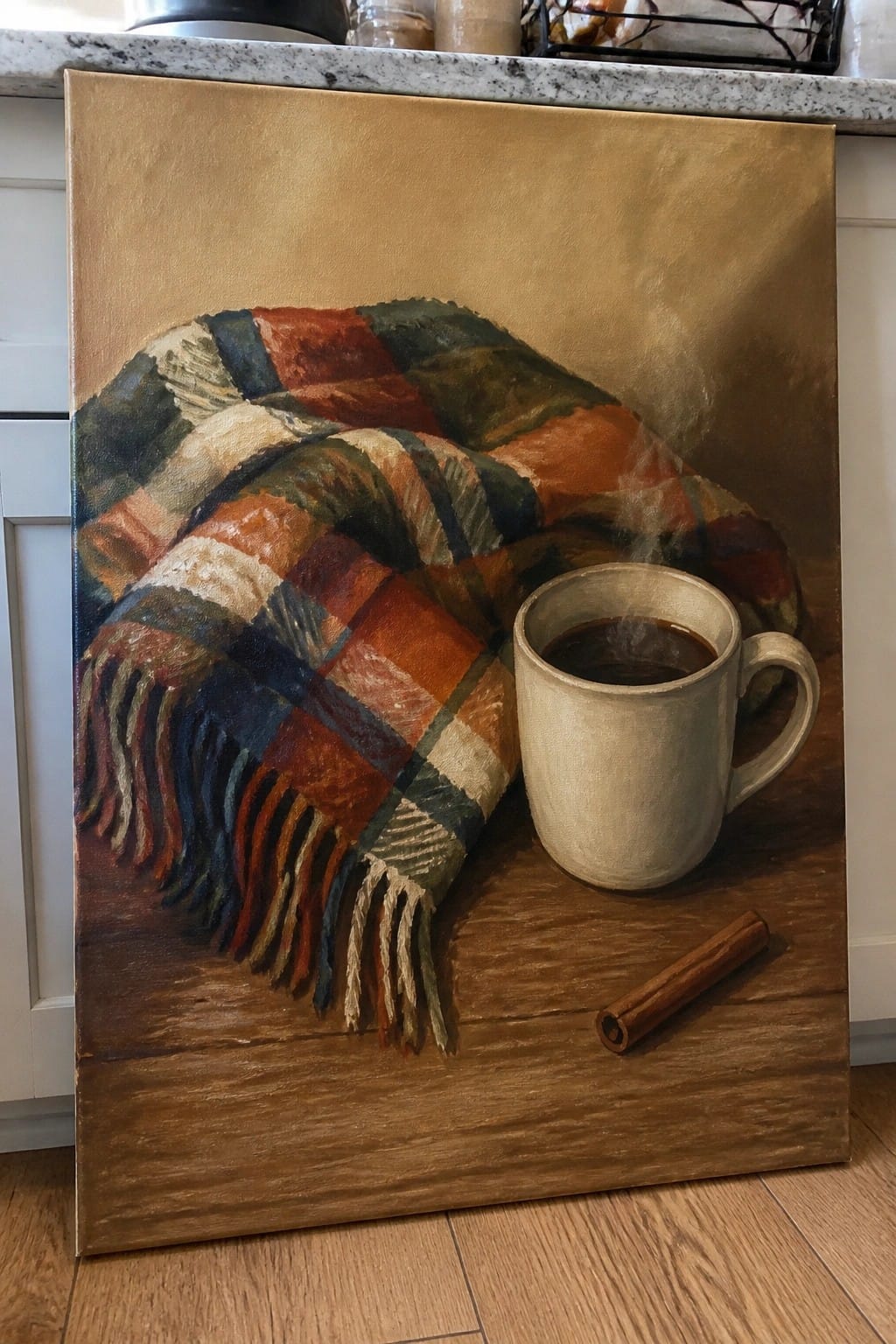 Plaid fringed blanket beside steaming coffee mug and cinnamon stick on wood