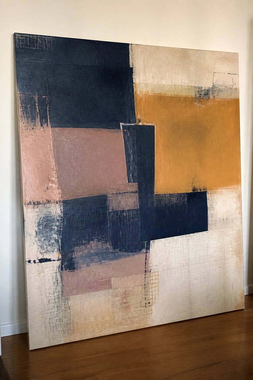 Large abstract painting with geometric blocks in navy, orange, pink and beige tones