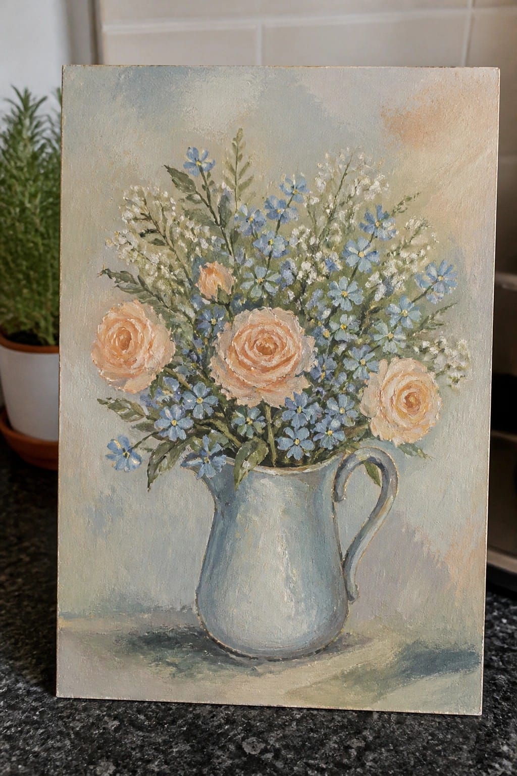 Painting of peach roses and blue forget-me-nots in a light blue pitcher.