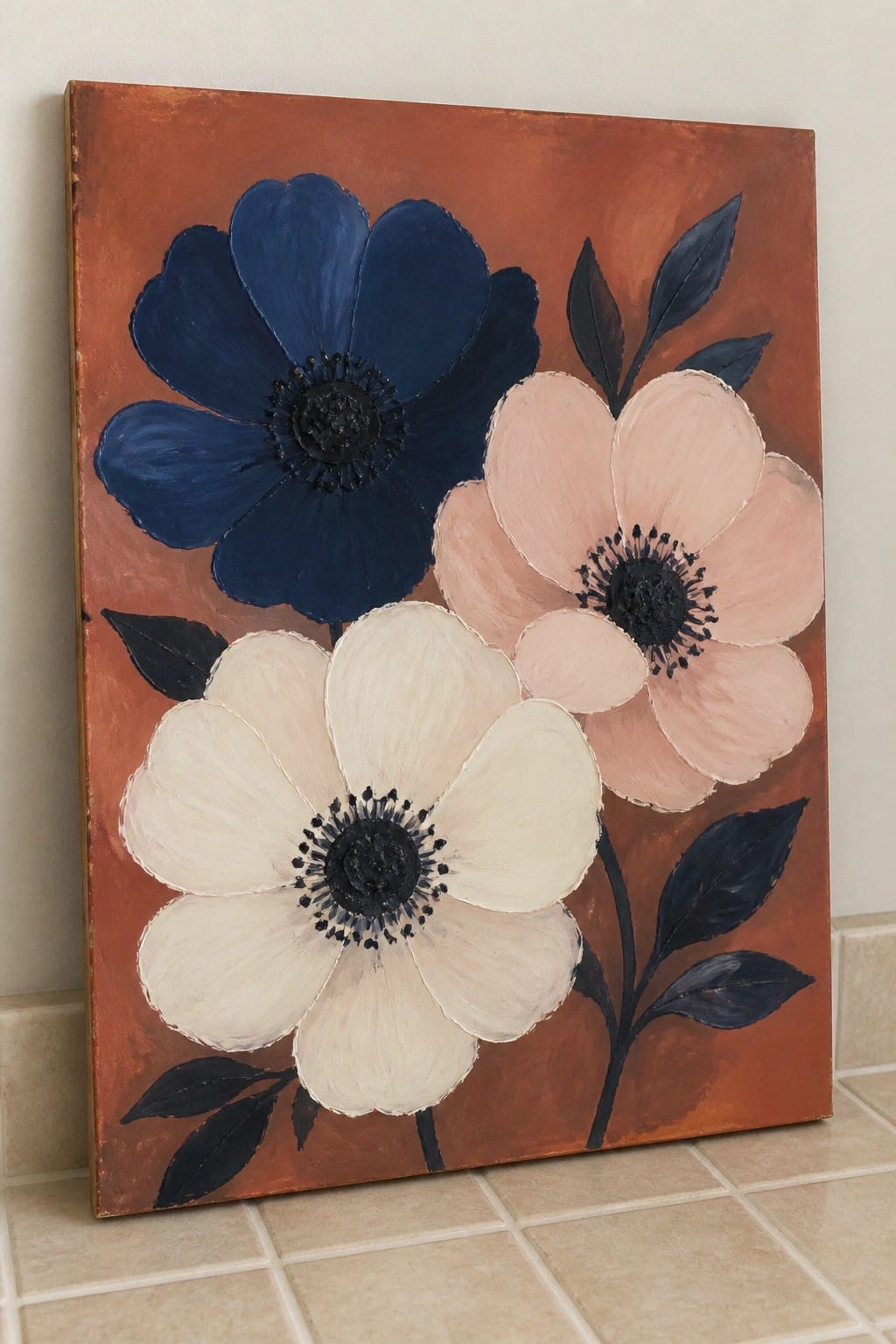 Large blue, pink, and white flowers painted on textured orange canvas