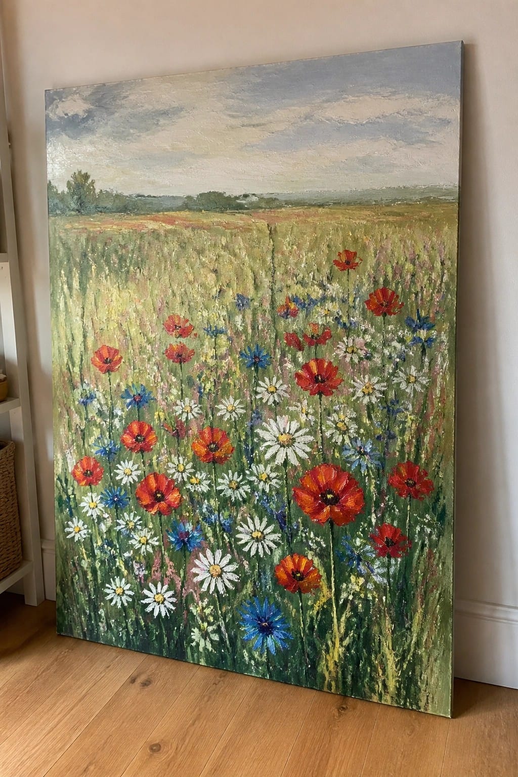 Vivid painting of red poppies, white daisies and blue flowers in a grassy field.