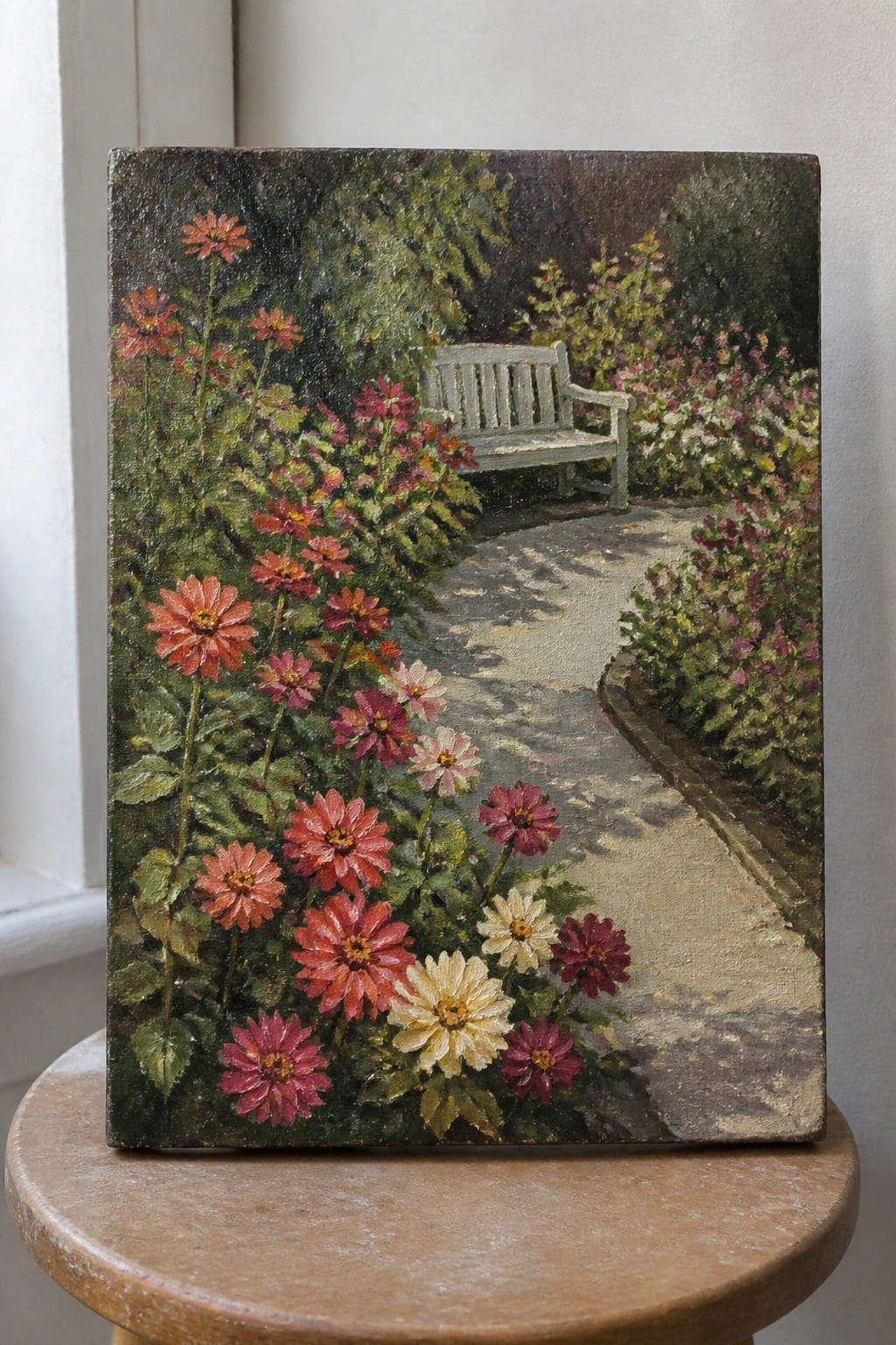 Vibrant painting of flowers lining a garden path with white bench on stool