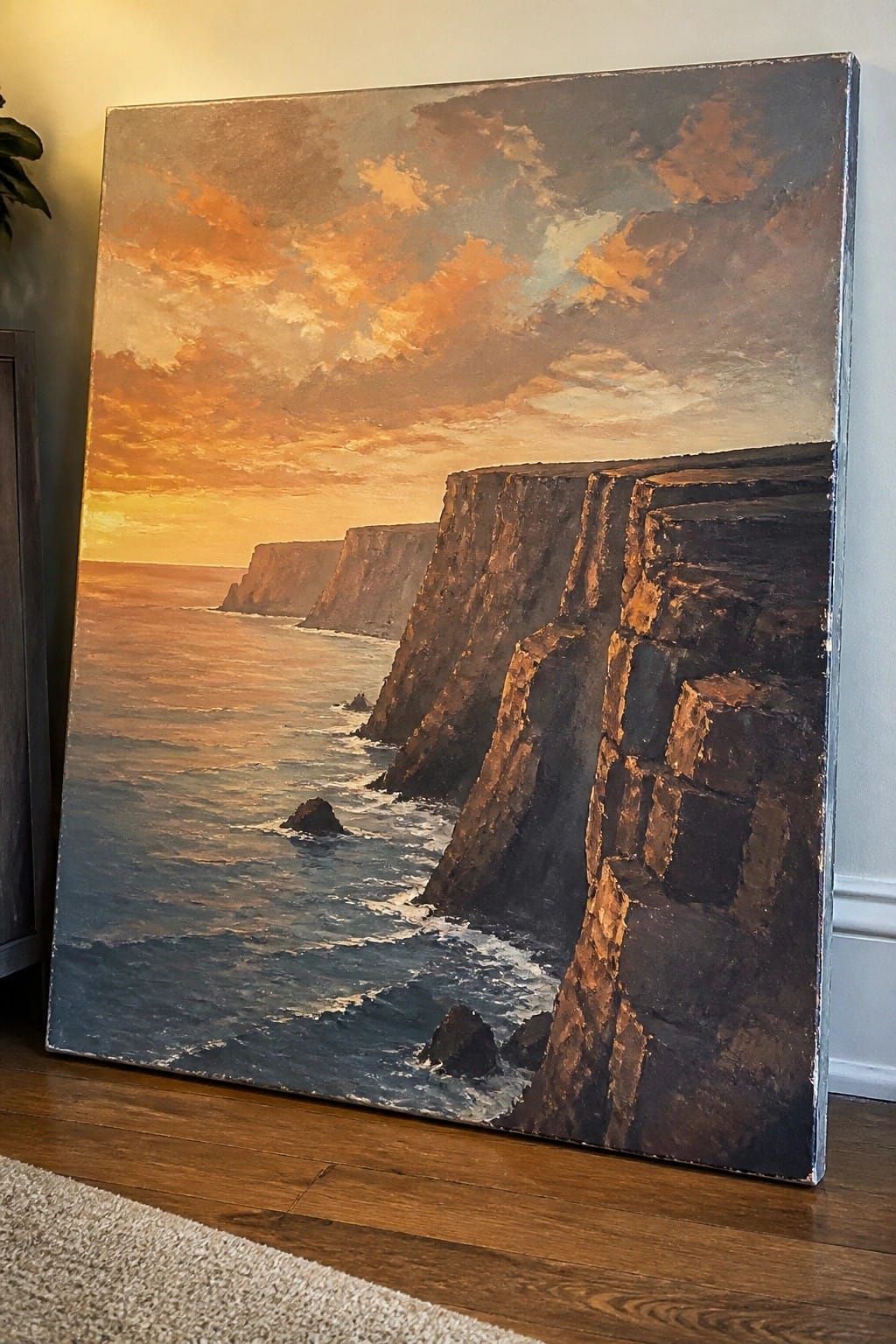 Oil painting of rugged cliffs meeting ocean waves under vibrant orange sunset sky