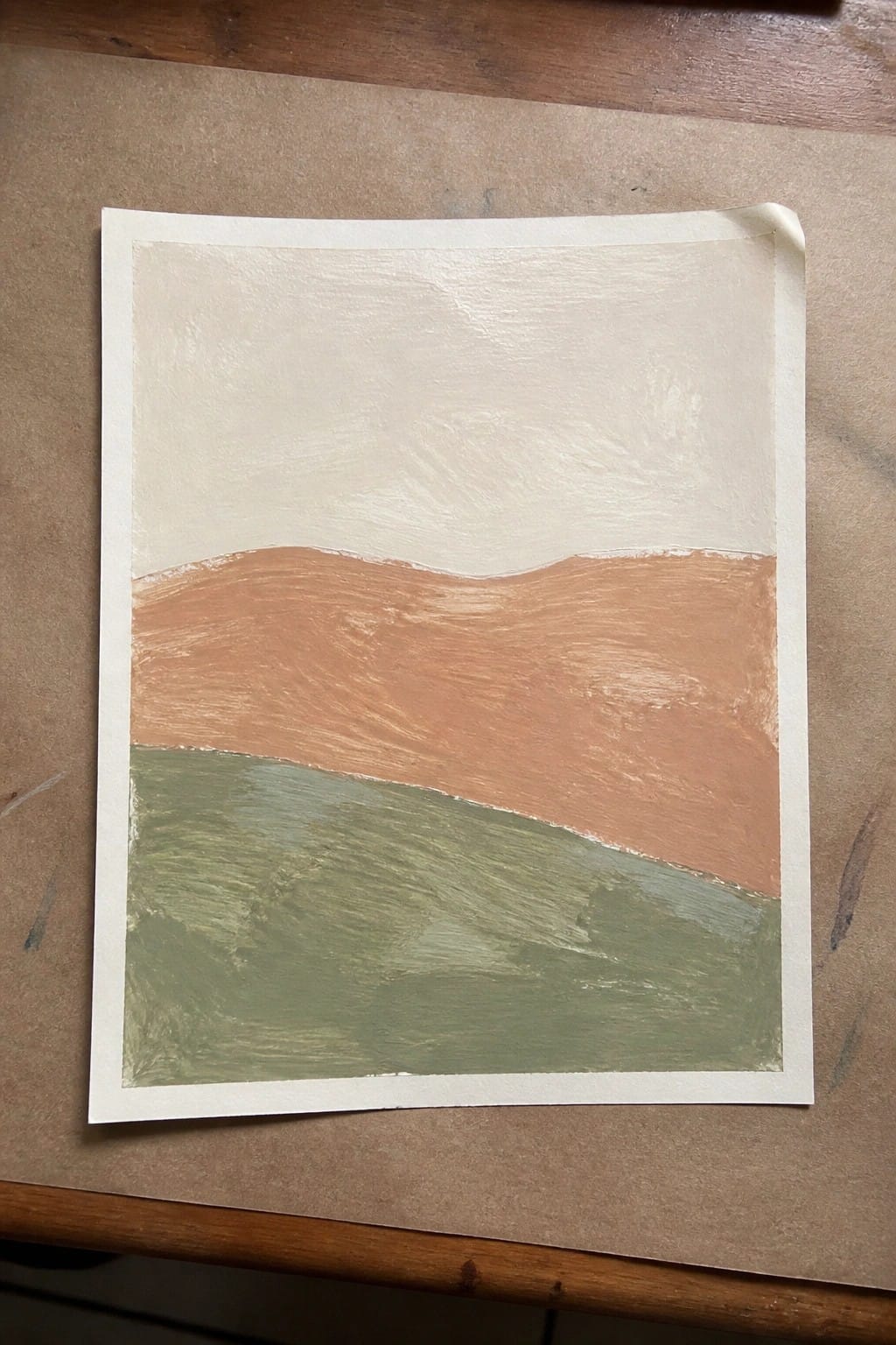 Abstract landscape painting with cream sky, terracotta hills, and green field on paper.