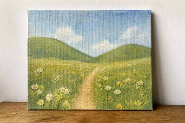 21 Stunning Oil Painting Landscape Ideas for Every Skill Level Winding dirt path through meadow of yellow and white wildflowers with green hills beyond.