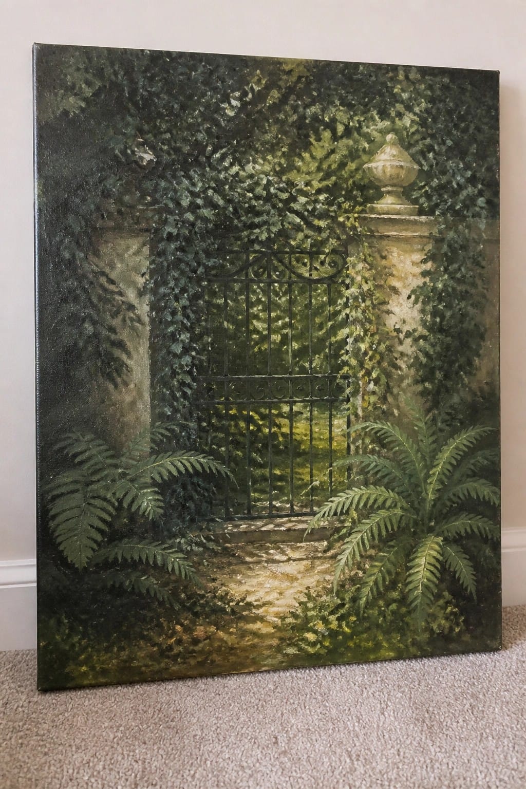 Overgrown ivy and ferns frame a black wrought-iron gate between mossy stone pillars.