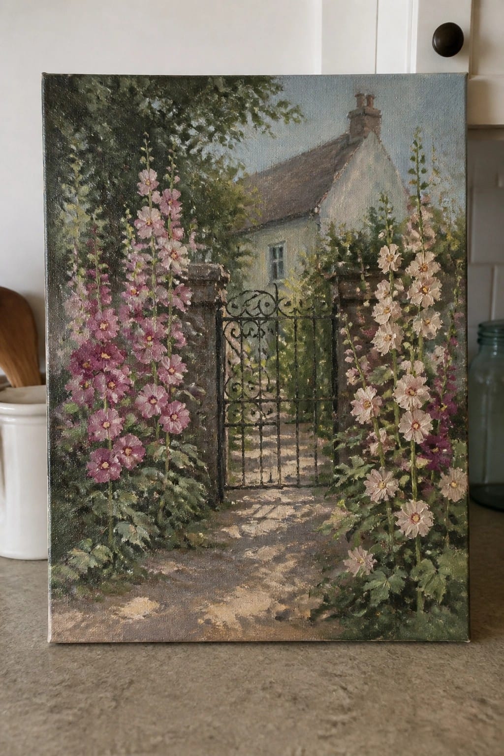 Oil painting of pink hollyhocks beside an ornate black gate leading to a cottage