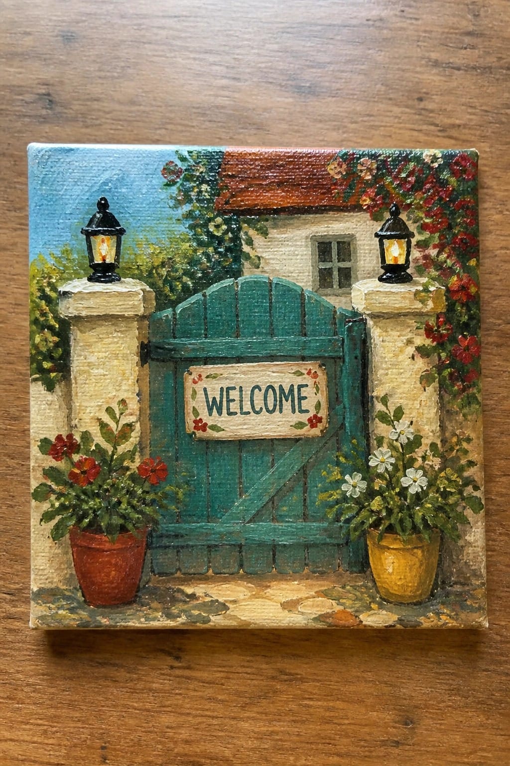 Colorful painting of teal gate with welcome sign, lanterns on pillars, and potted flowers
