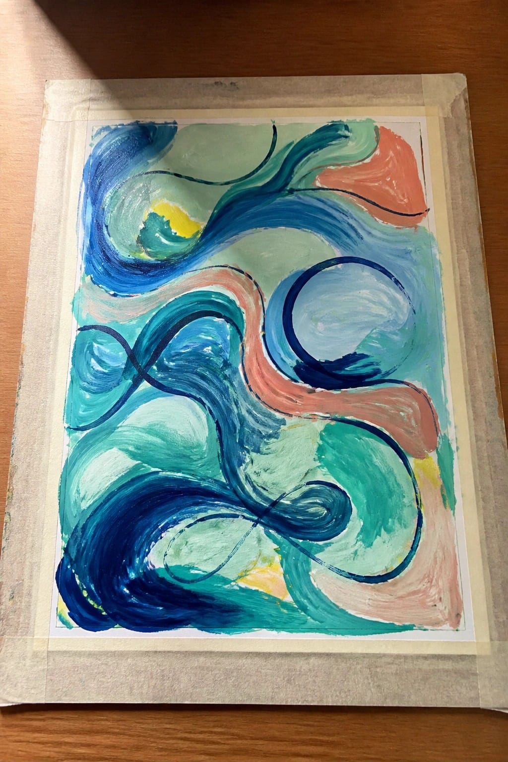 Abstract painting with swirling blue green teal coral and yellow brushstrokes on taped paper