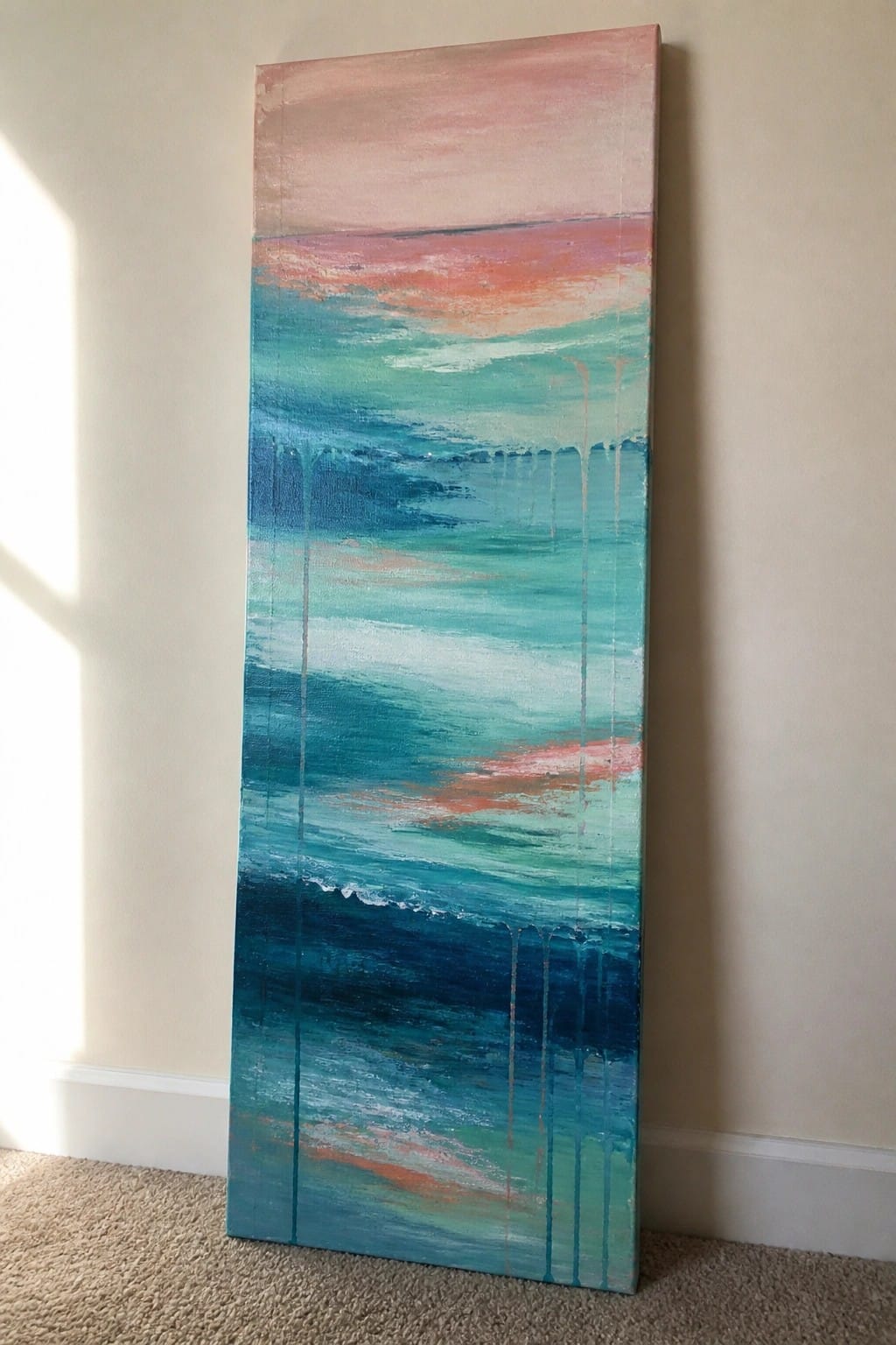 A tall vertical abstract oil painting shows horizontal bands of pink sky over turquoise and deep blue ocean layers with scattered vertical drips.