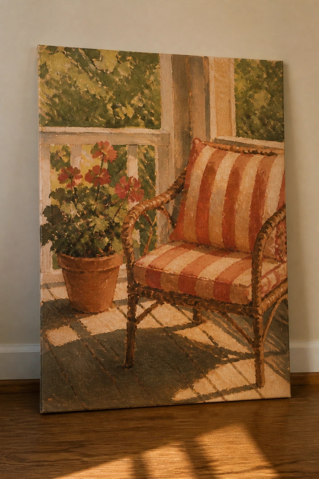 Striped wicker chair beside potted red flowers on sunlit wooden porch