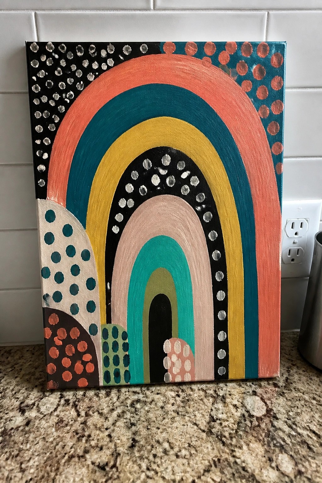 Colorful abstract rainbow painting with arched bands and polka dot patterns on canvas