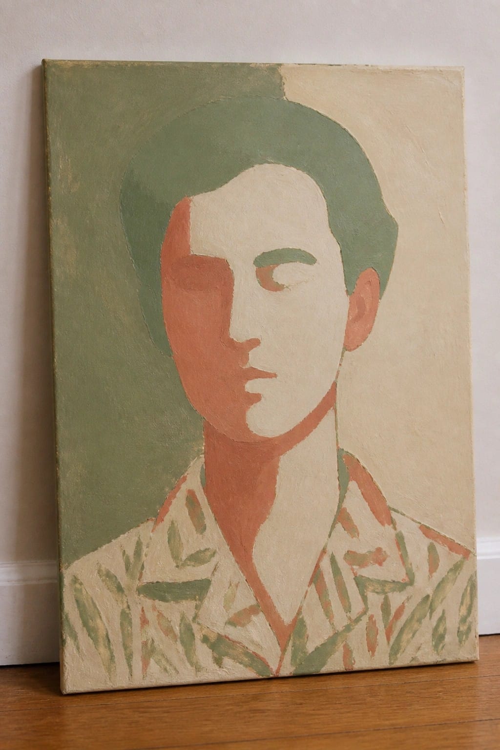 Abstract portrait with split red-and-white face, green hair, and patterned shirt