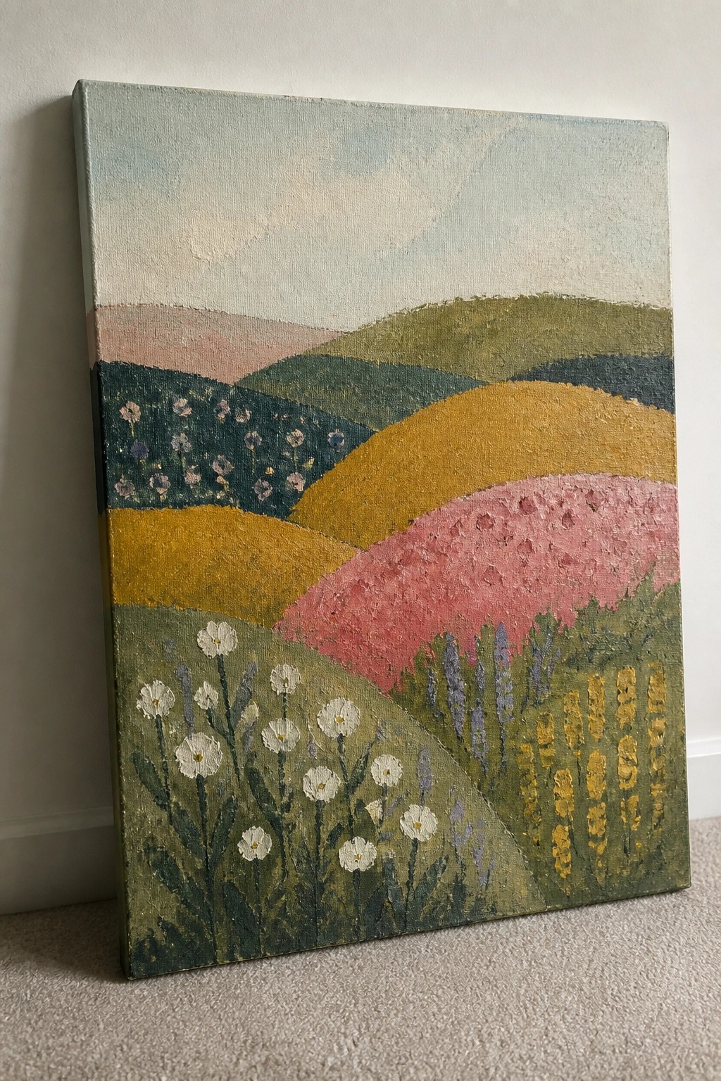 Colorful abstract landscape painting of rolling hills with wildflowers in greens, yellows, and pinks.