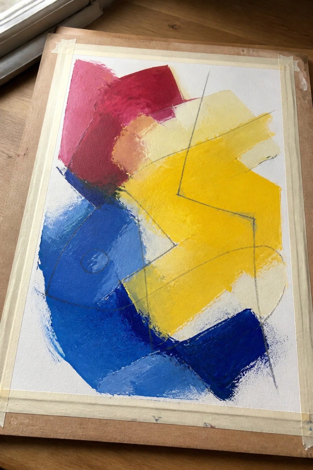 Abstract painting with overlapping red, blue, and yellow geometric shapes on paper.