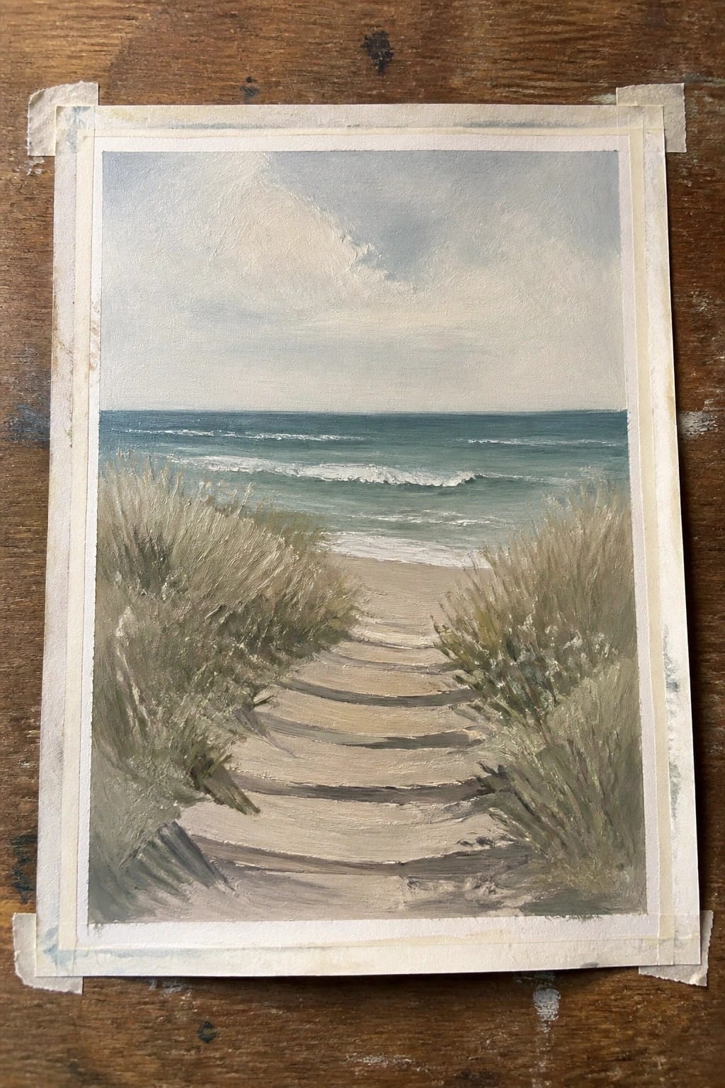 Seascape painting of sandy path through grasses leading to wavy ocean.