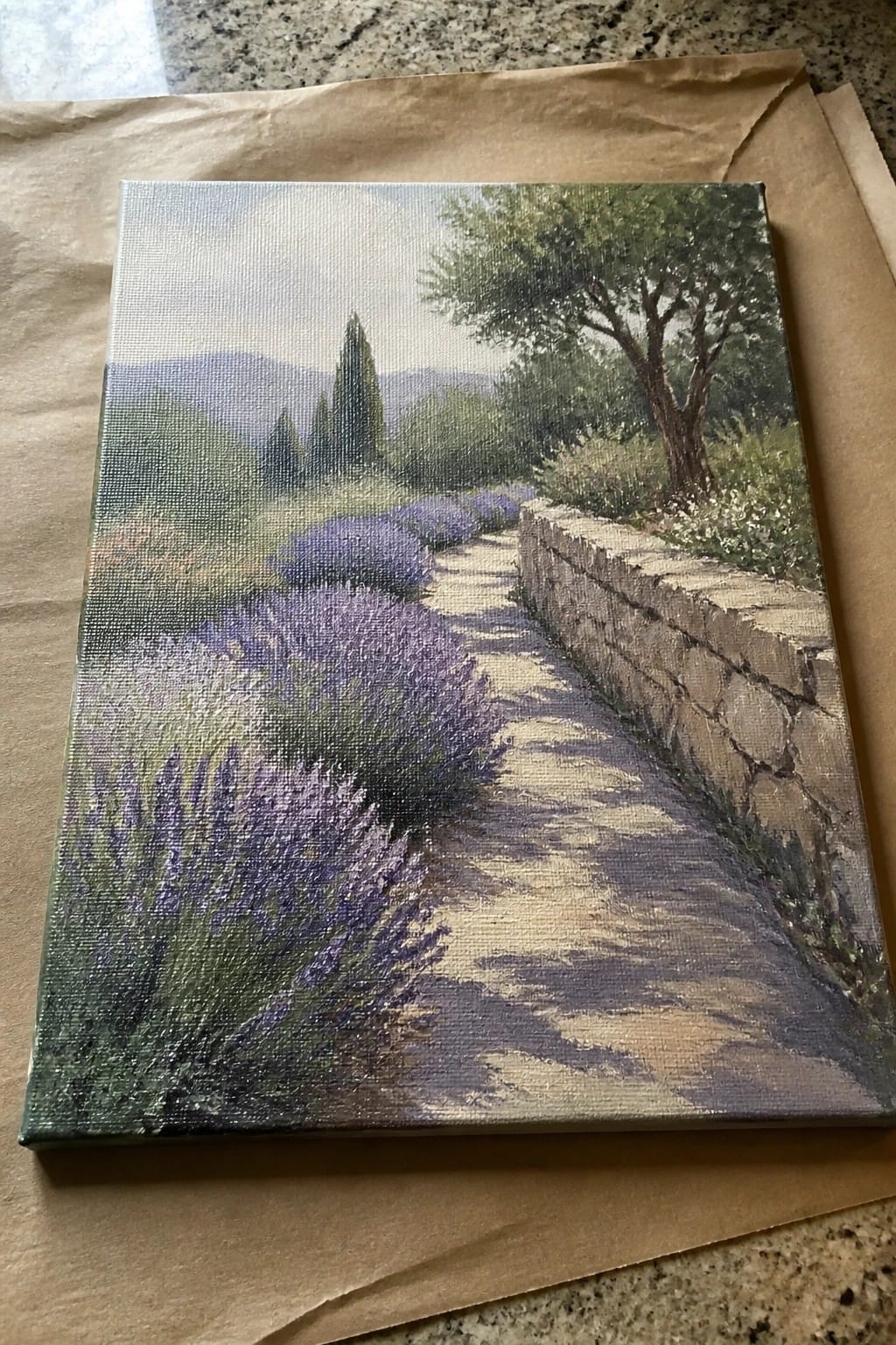 Impressionistic painting of lavender bushes lining a sunlit path beside a stone wall.