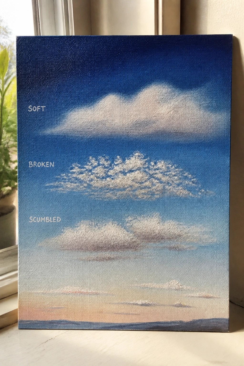 Canvas painting of gradient blue sky with soft, broken, scumbled cloud examples.