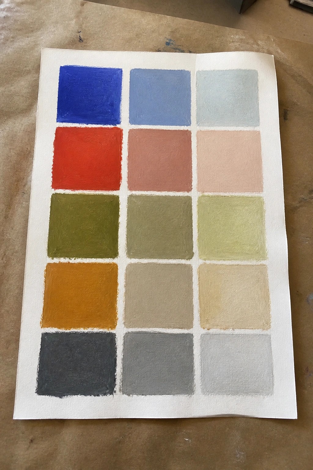 Grid of fifteen painted color swatches in five rows on white paper