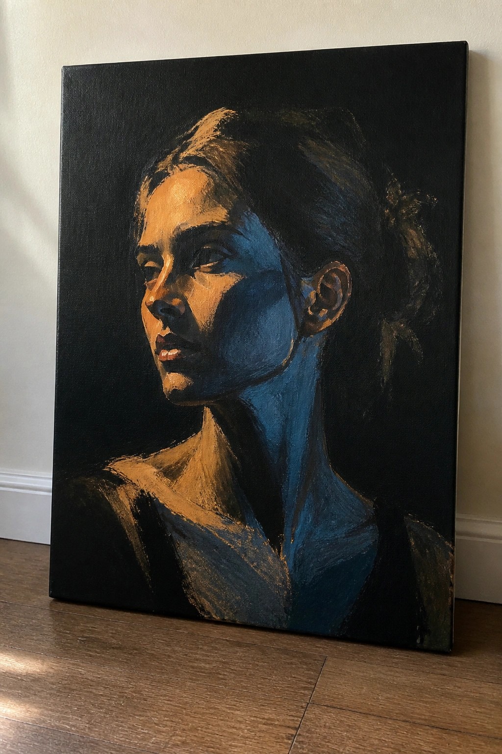 Realistic oil painting of a woman shown from the shoulders up with dramatic blue and warm gold lighting against a solid black background on canvas.