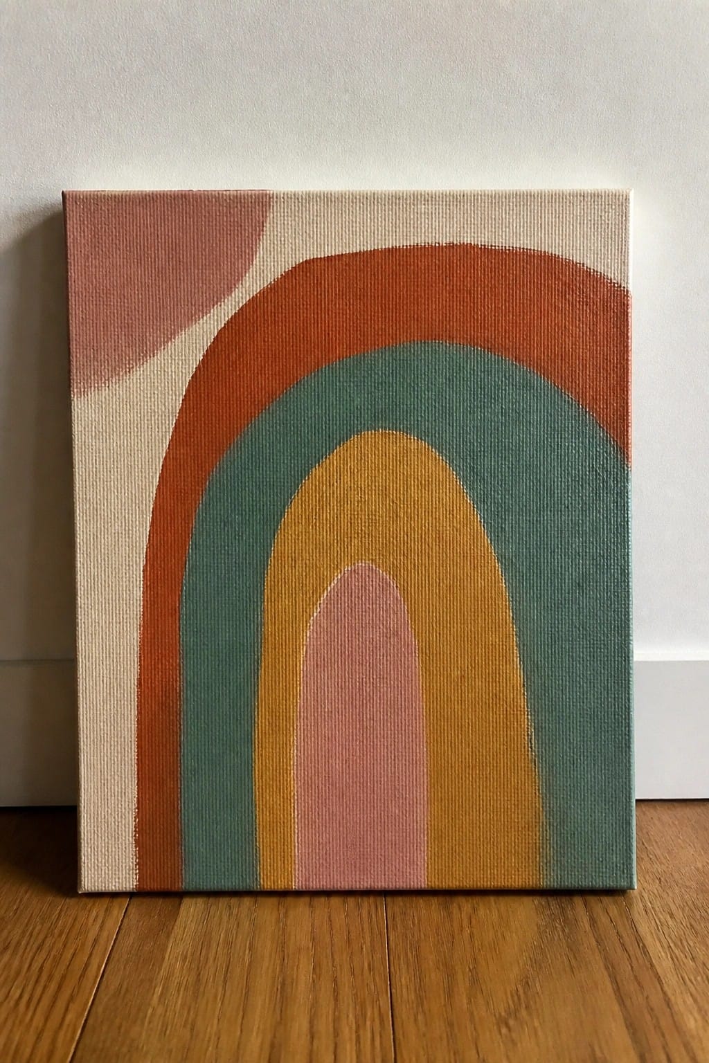Abstract rainbow canvas art with terracotta, teal, mustard, and blush arches on beige background