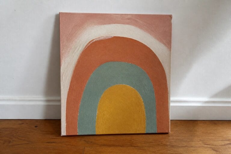 Abstract rainbow canvas art with terracotta, teal, mustard, and blush arches on beige background