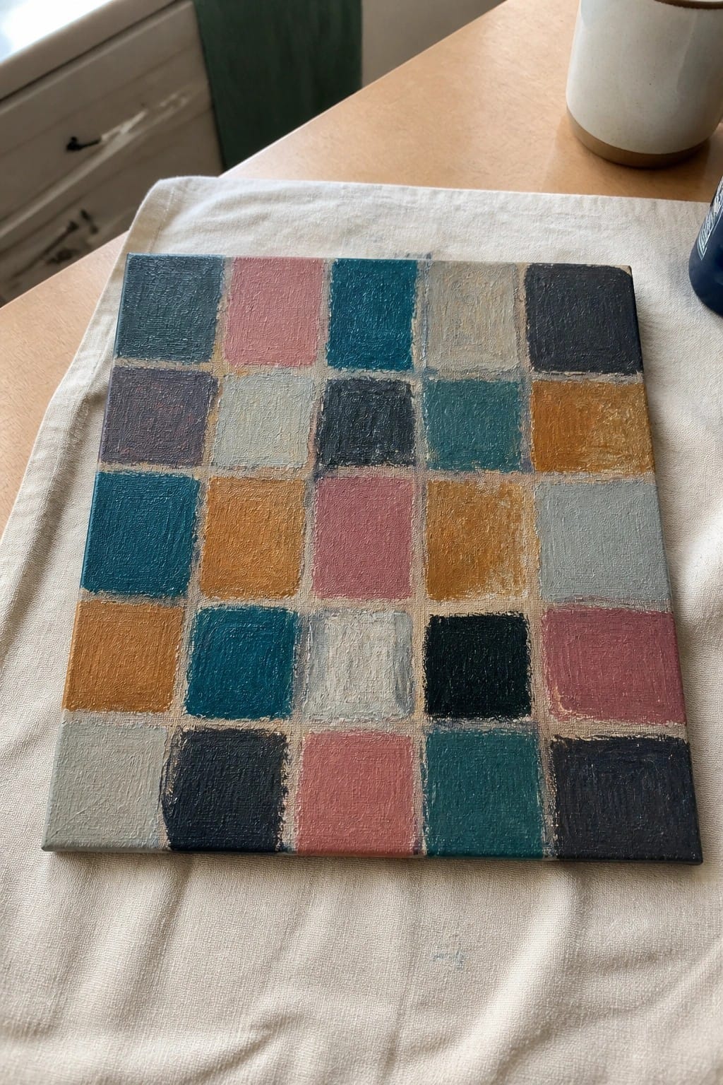 Colorful grid painting with squares in blue pink orange gray on canvas