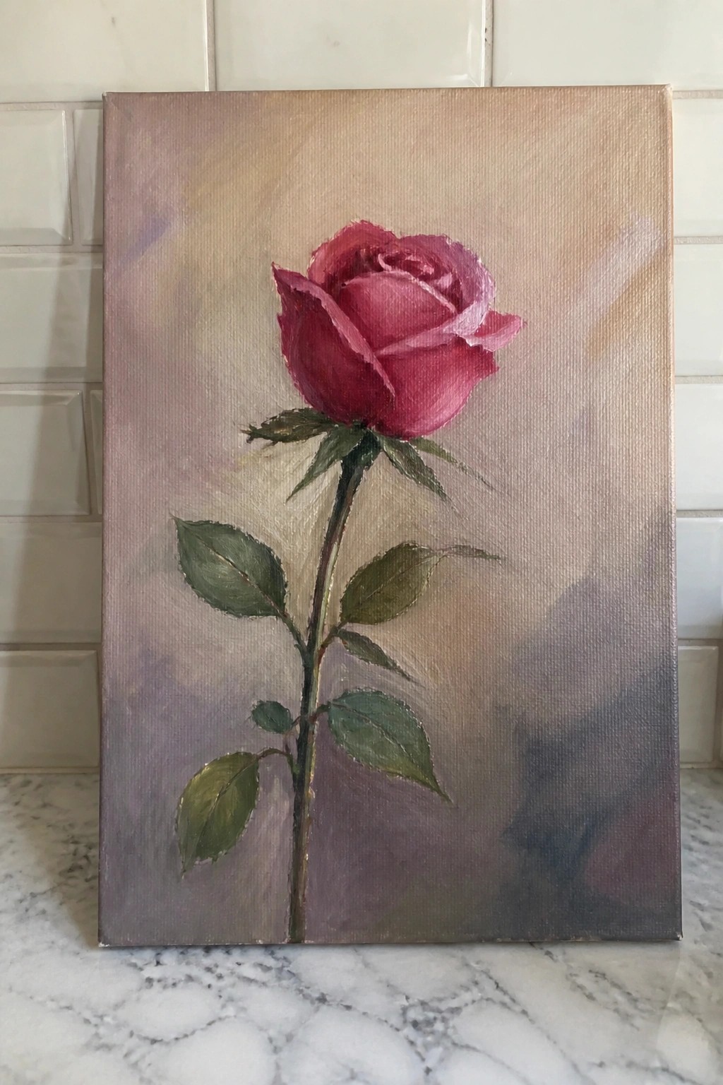 Oil painting of single red rose with green leaves on canvas with soft background