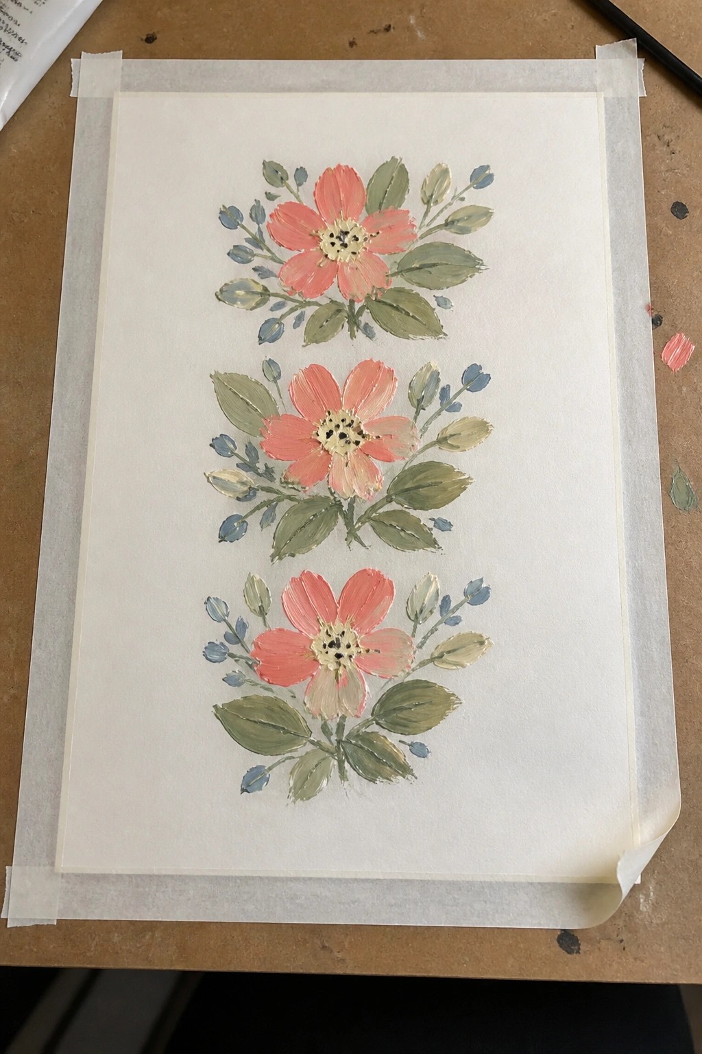 Three coral-pink flowers with green leaves and blue buds in watercolor style