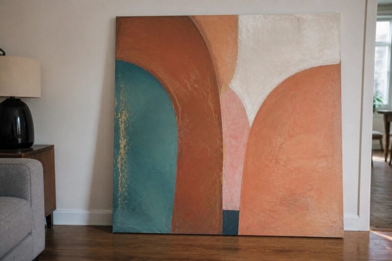 22 Large Abstract Oil Paintings Designed for Modern Open Spaces Abstract painting with curved shapes in terracotta, sage green, and beige against a wall