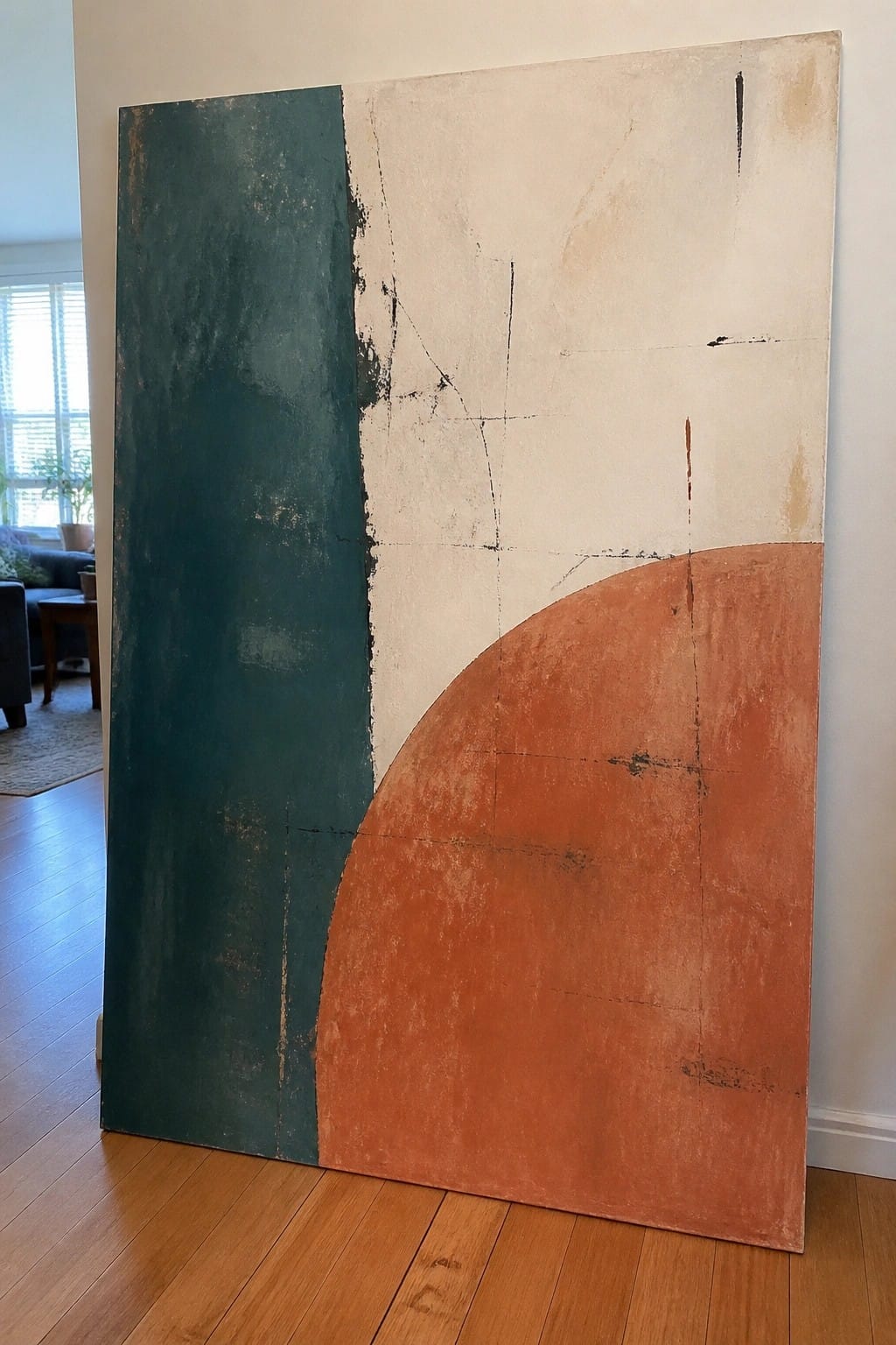 Large abstract painting with teal panel, white lines, and orange curve against wall