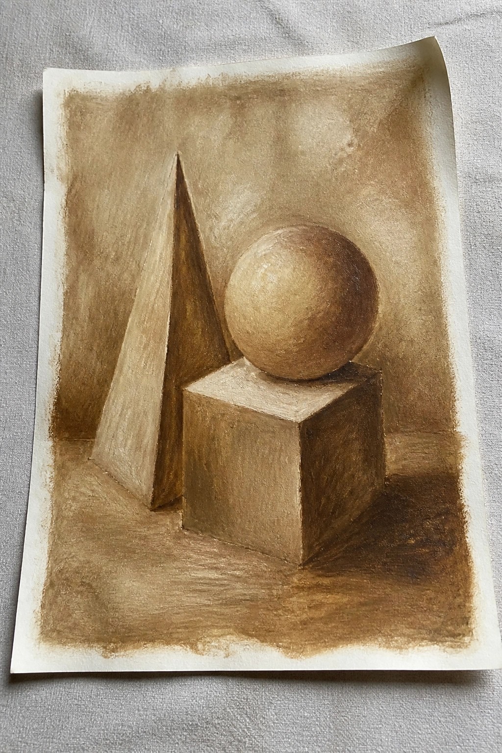 Monochrome brown still life with cone, cube topped by sphere and shadows