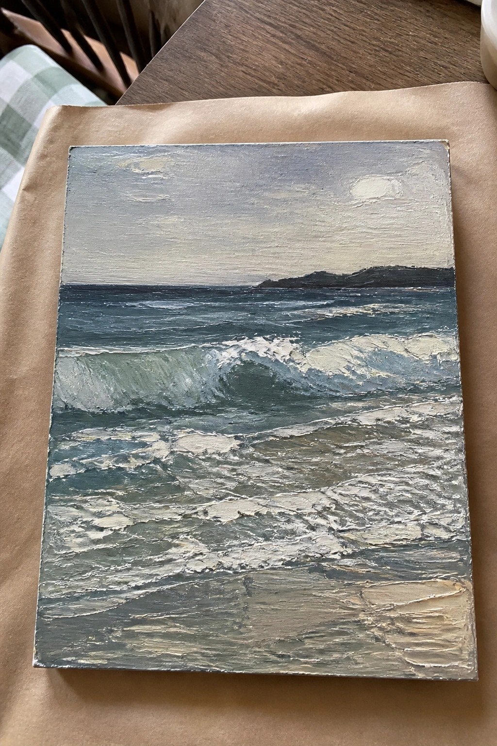 Textured oil painting of crashing blue-green waves with white foam and distant hills.
