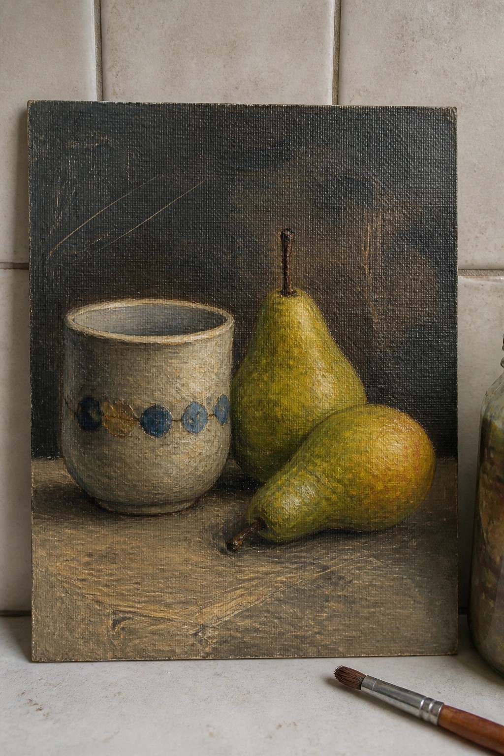 Still life painting of dotted ceramic cup beside two green pears on canvas