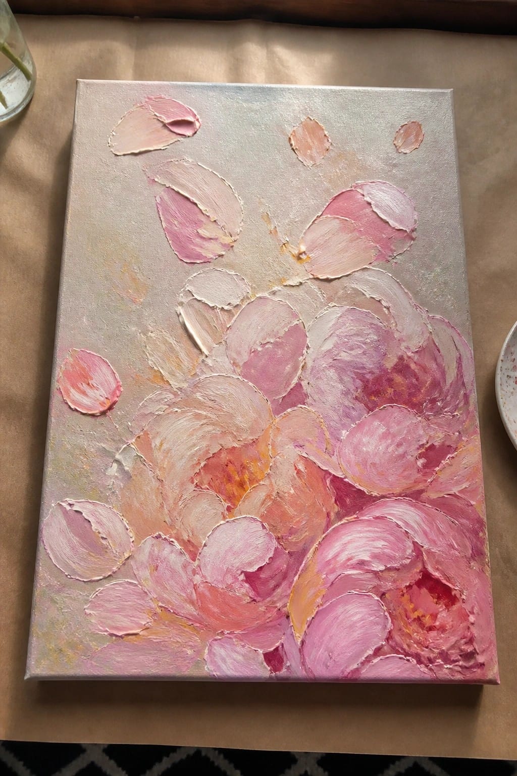 Thick impasto painting of blooming pink and coral peonies on light canvas.