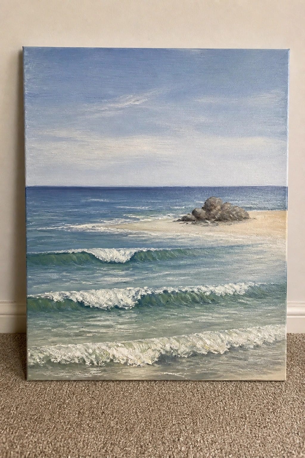 Ocean painting with turquoise waves, white foam, sandy beach, and rocks under blue sky