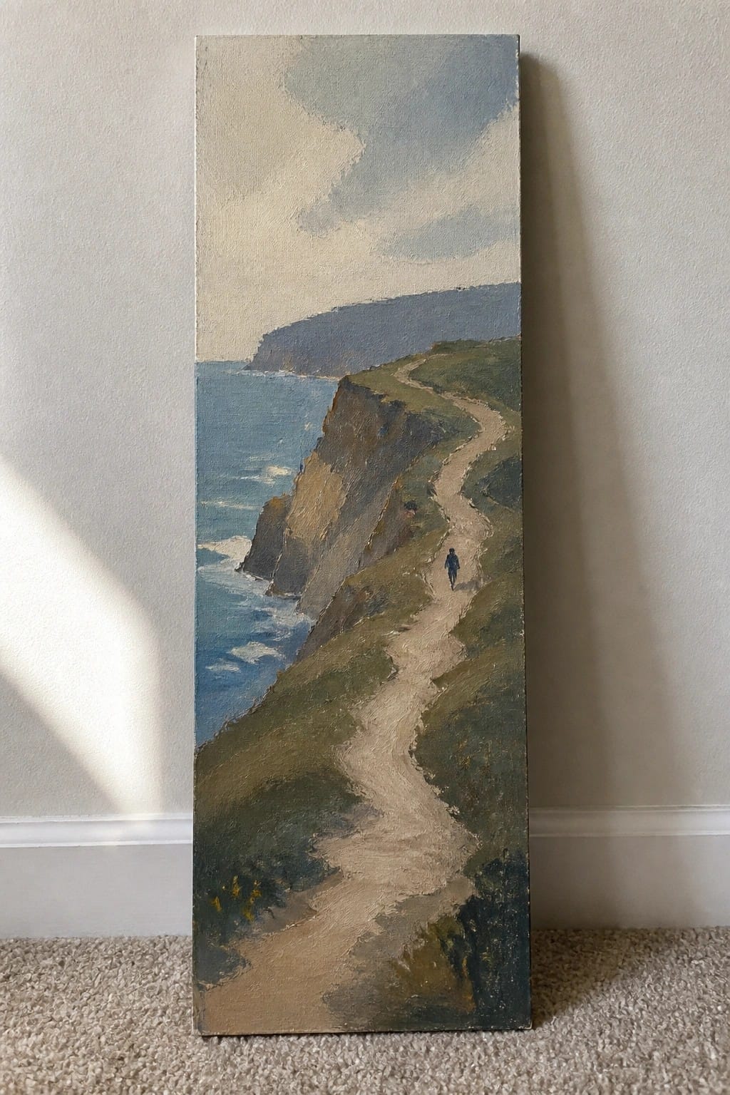 Vertical painting of winding cliff path beside blue ocean with lone walker under cloudy sky.