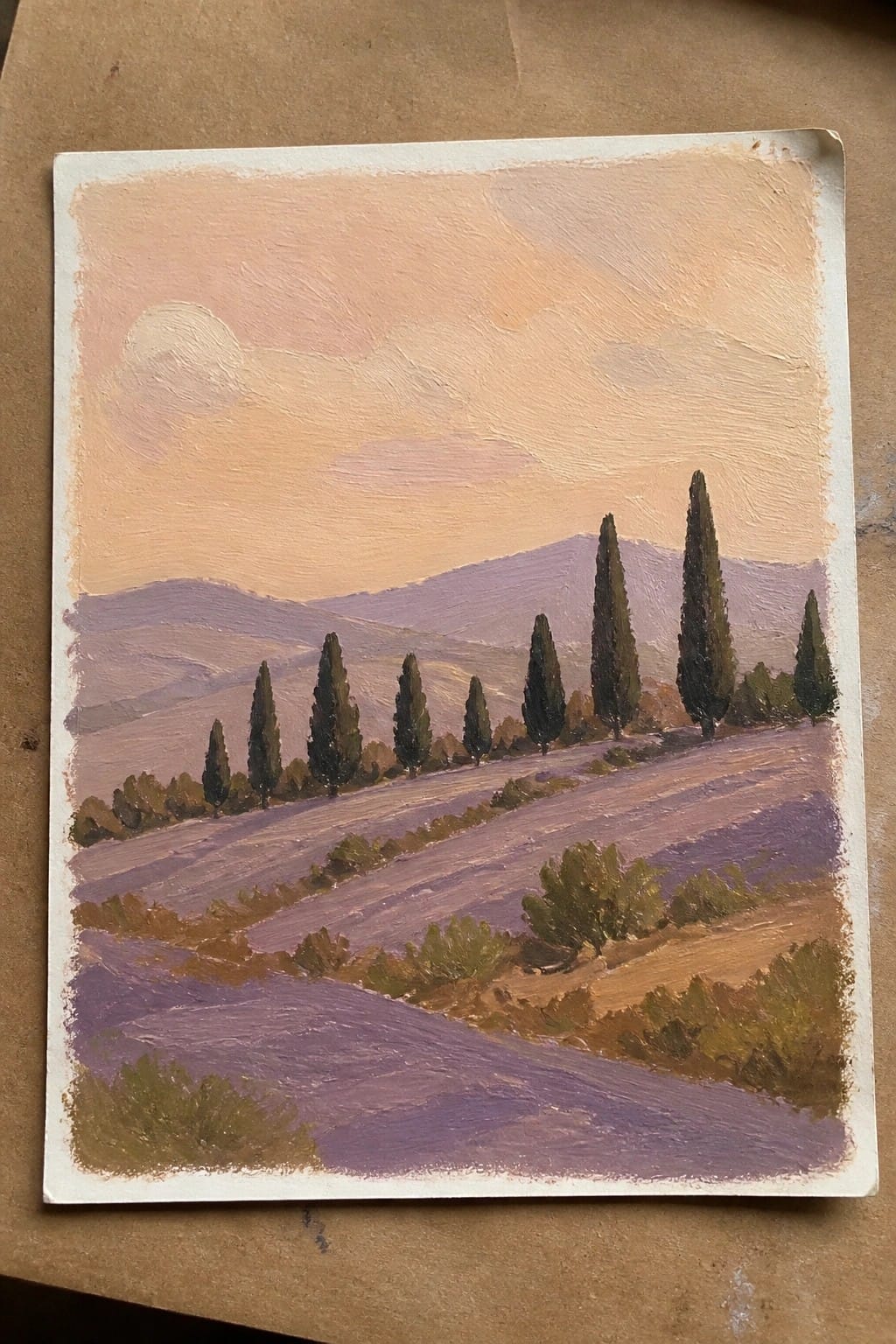 Oil painting of lavender fields, cypress trees, and rolling hills under a peach sky.