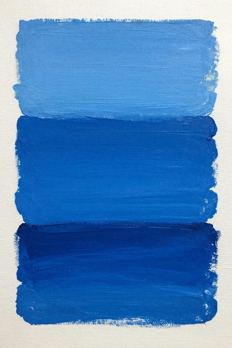Three horizontal blue paint strokes in descending shades on white canvas