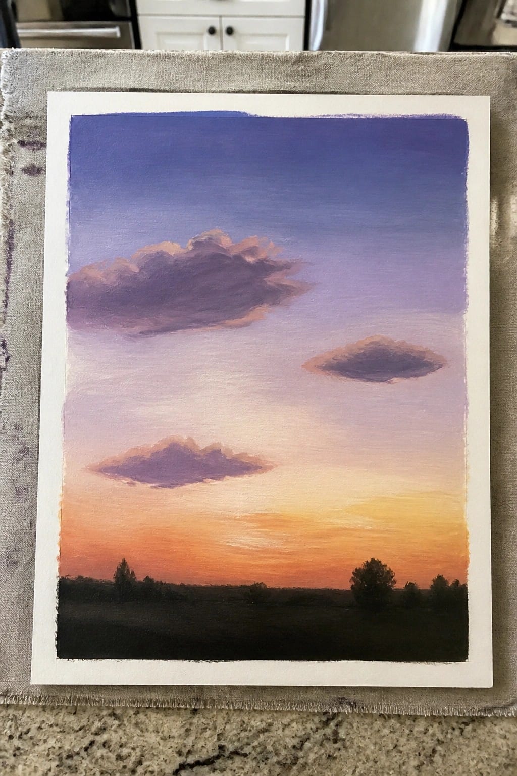An oil painting of a sunset sky blending from purple to orange with scattered clouds and a dark silhouetted landscape at the bottom.