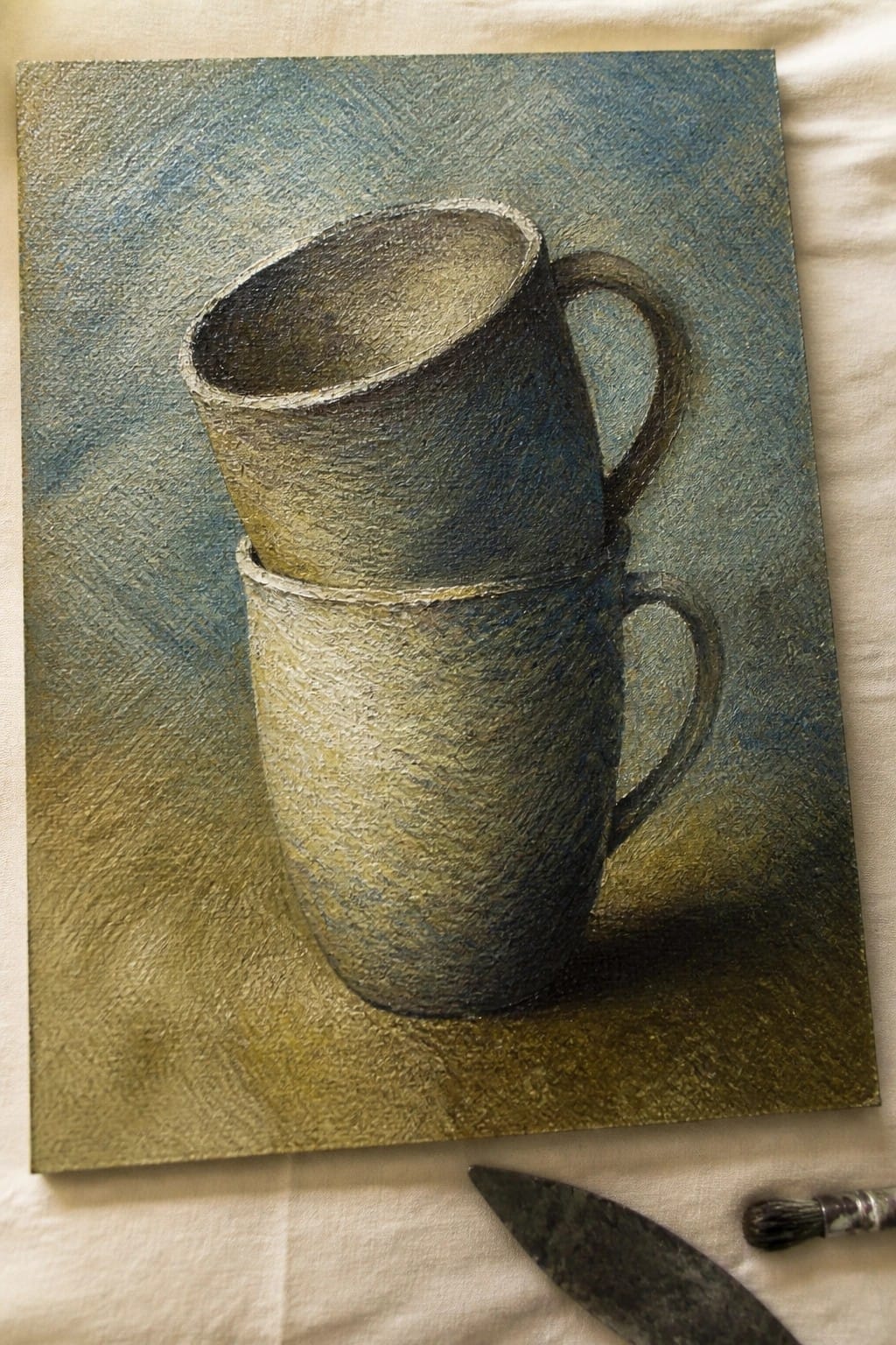Two stacked ceramic mugs in textured oil painting with palette knife and brush.
