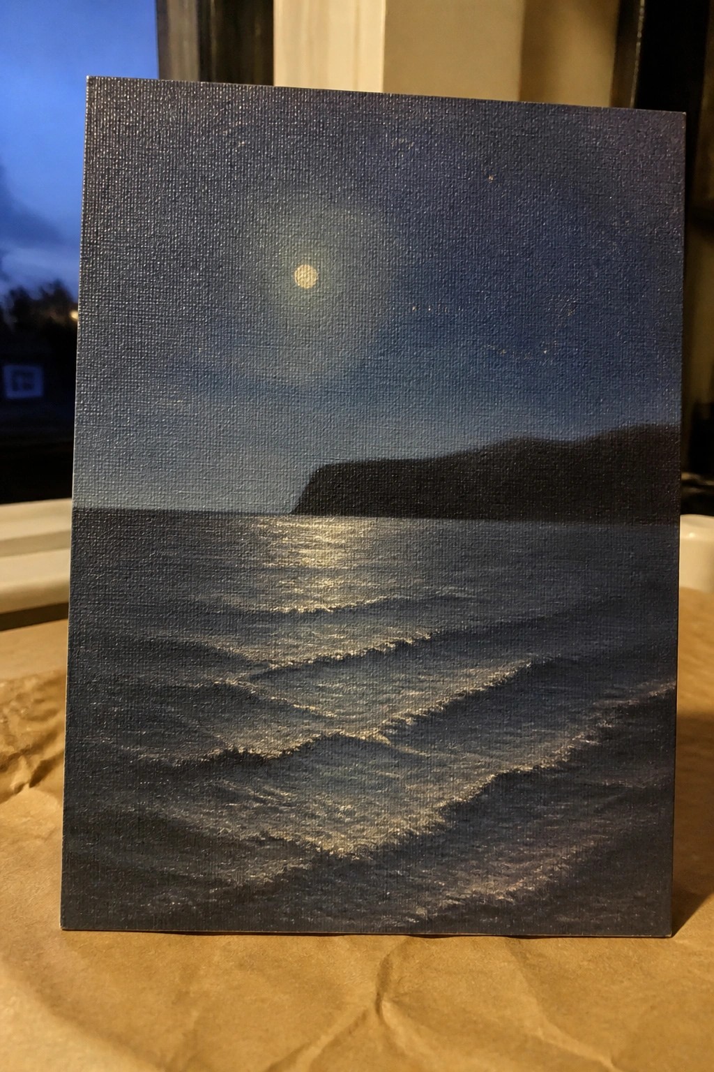 Painting of bright moon reflecting on dark rolling ocean waves beneath starry night sky