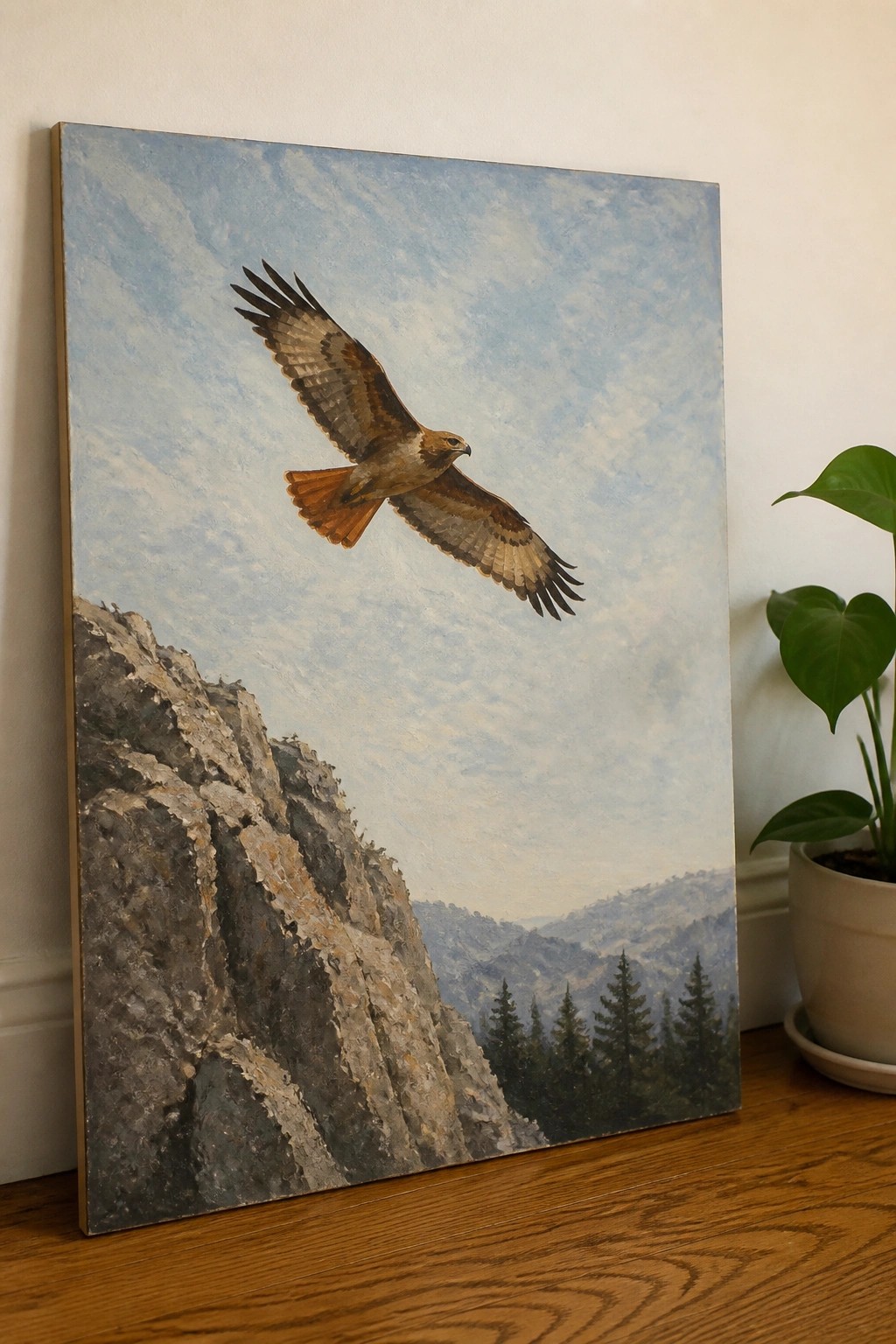 Realistic painting of a hawk soaring above rocky cliffs and pine-covered mountains