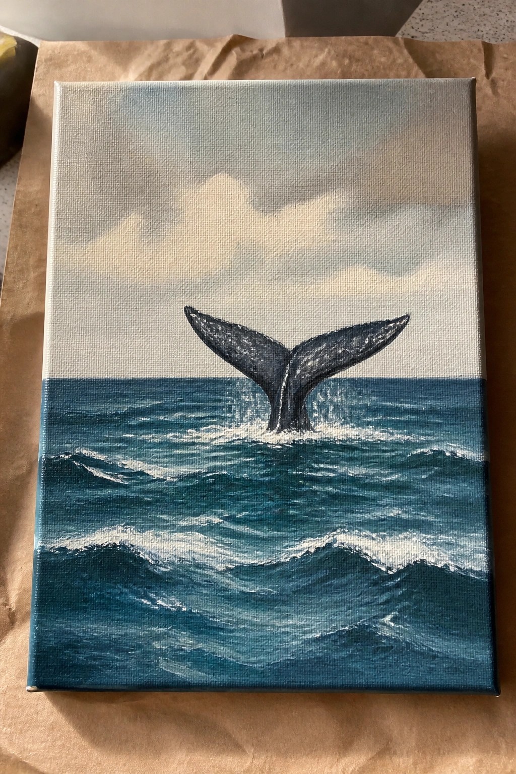 Canvas painting of whale tail splashing in blue ocean waves under cloudy sky