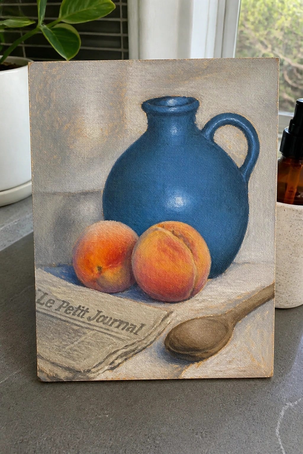 Blue pitcher with two peaches, wooden spoon, and Le Petit Journal newspaper on canvas