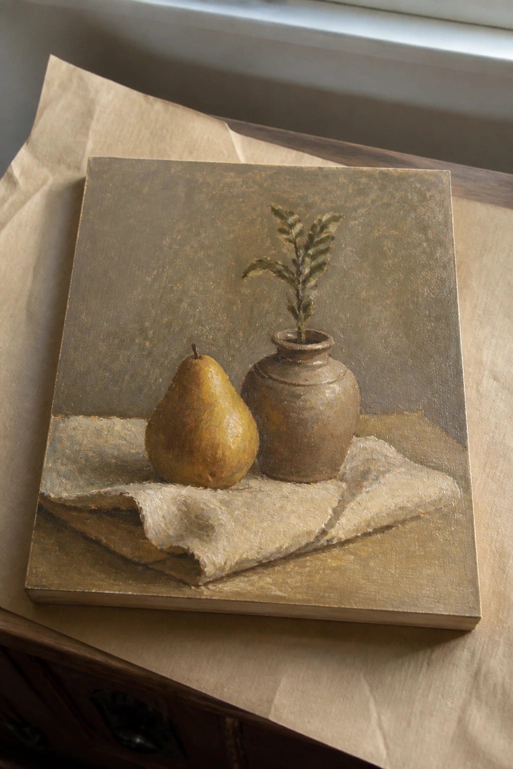Still life painting of yellow pear and brown vase with plant on cloth