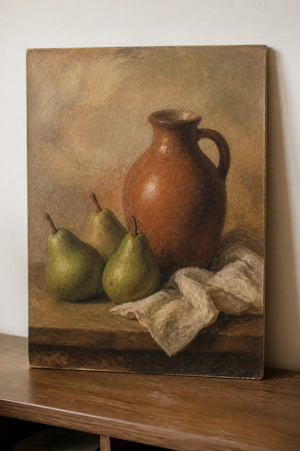 Three green pears beside brown ceramic jug and white cloth on wood