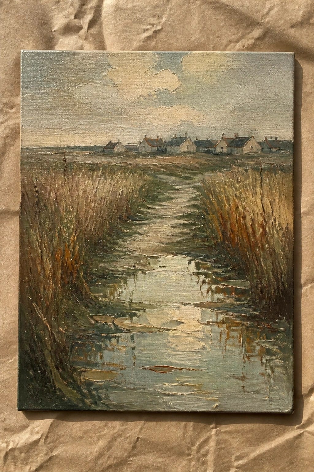 An oil painting of a narrow stream bordered by tall reeds that leads toward a row of small houses under a pale cloudy sky.