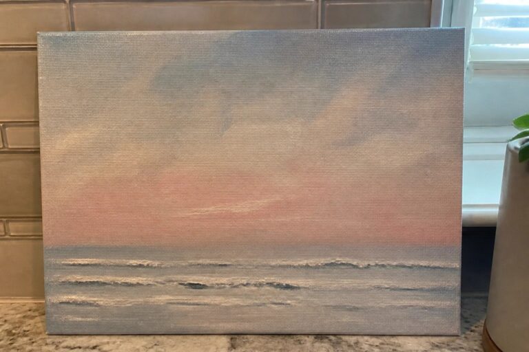 23 Dreamy Seascape Oil Painting Ideas That Create Depth and Movement on Canvas Painting of pink sunset over gray ocean waves on canvas leaning by tiles